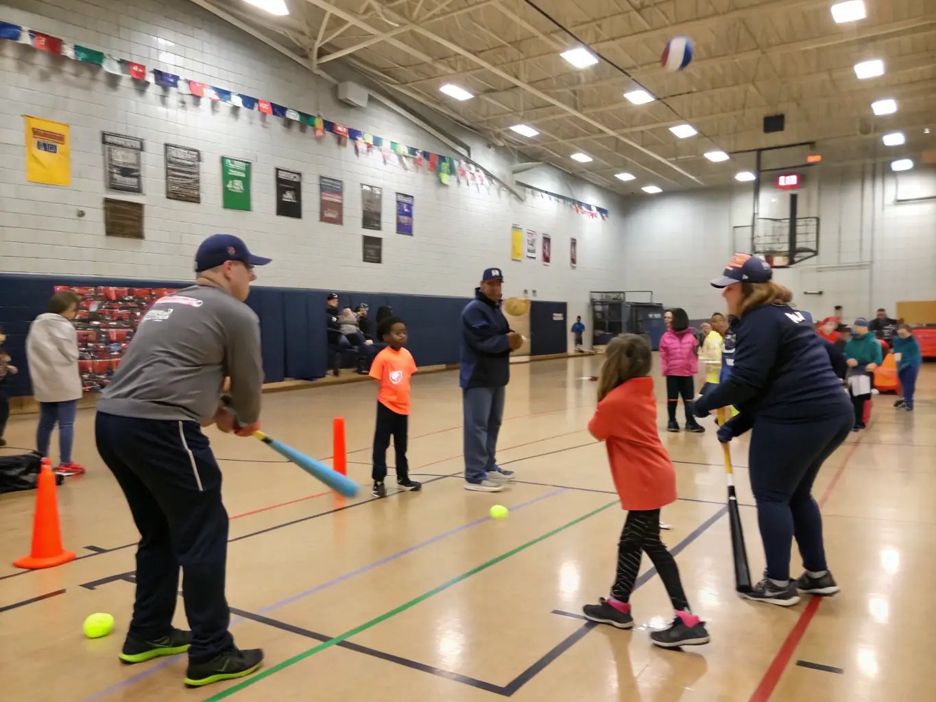 A photograph of HCCA volunteers organizing a community event, such as a hockey clinic for underprivileged children, demonstrating their commitment to social responsibility.